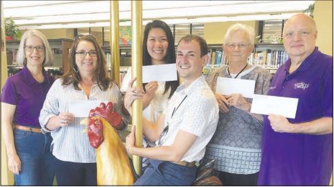 nonprofit representatives receiving check from fairfield glade ladies invitational golf tournament committee